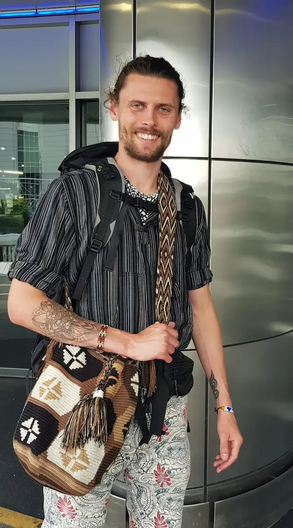 Daniel Hannah with all of his backpacks at the airport